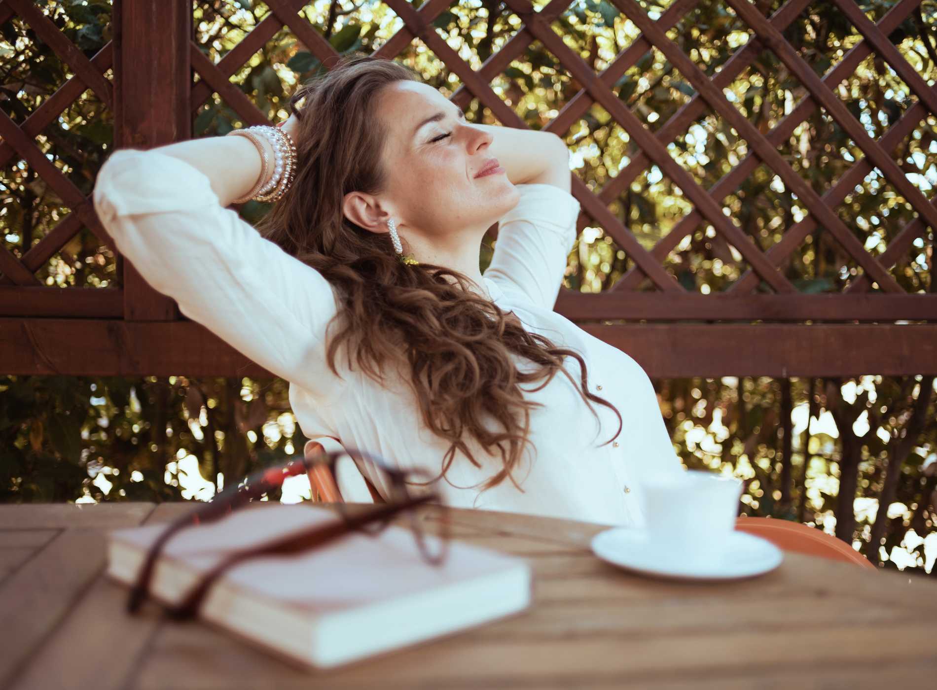 relaxed housewife in white shirt sitting at table