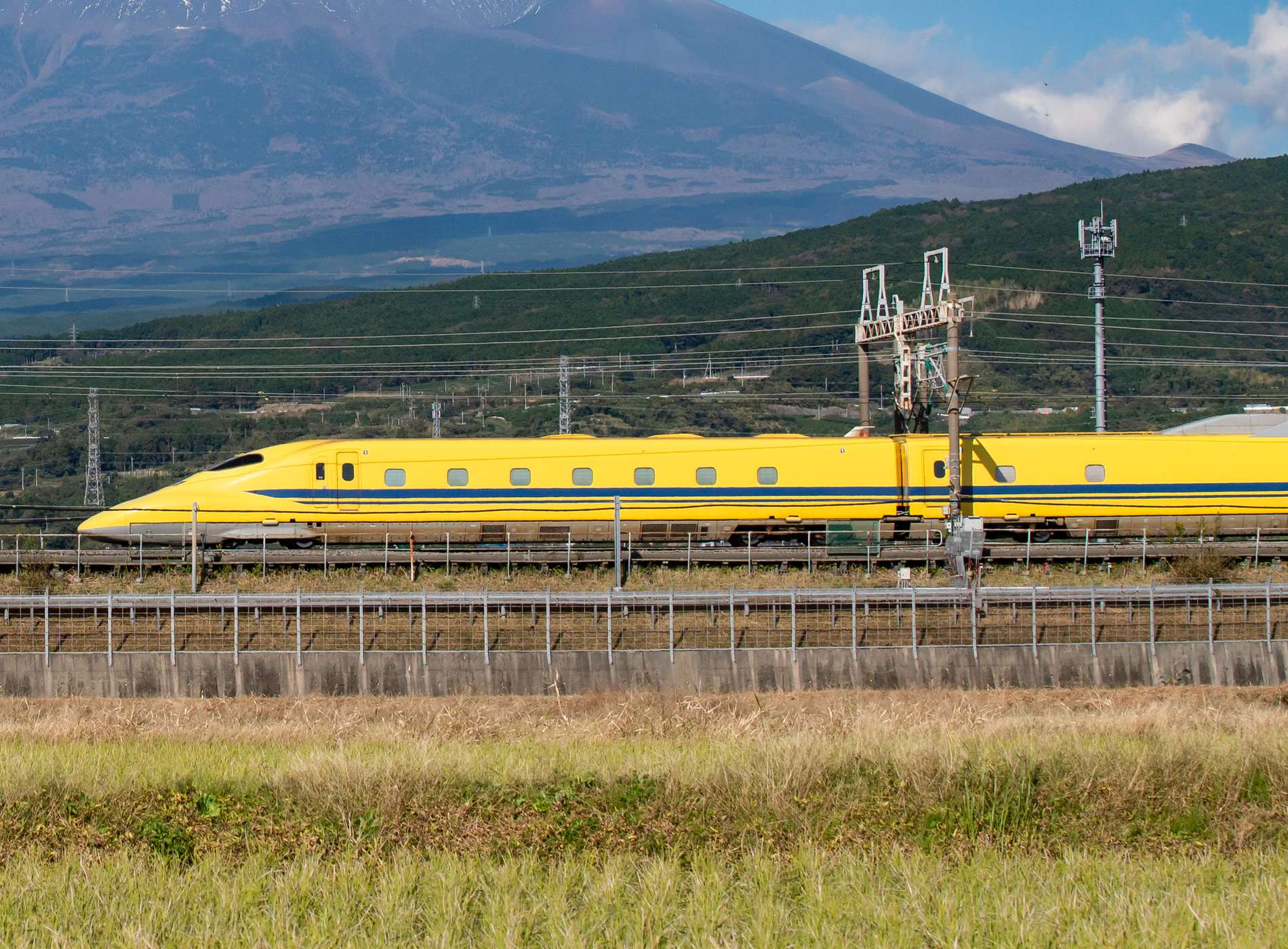 Japan - November 15. 2019 : High Speed Bullet Train Doctor Yellow Shinkansen  on railway with Fuji Mountain Background, Fuji, Shizuoka