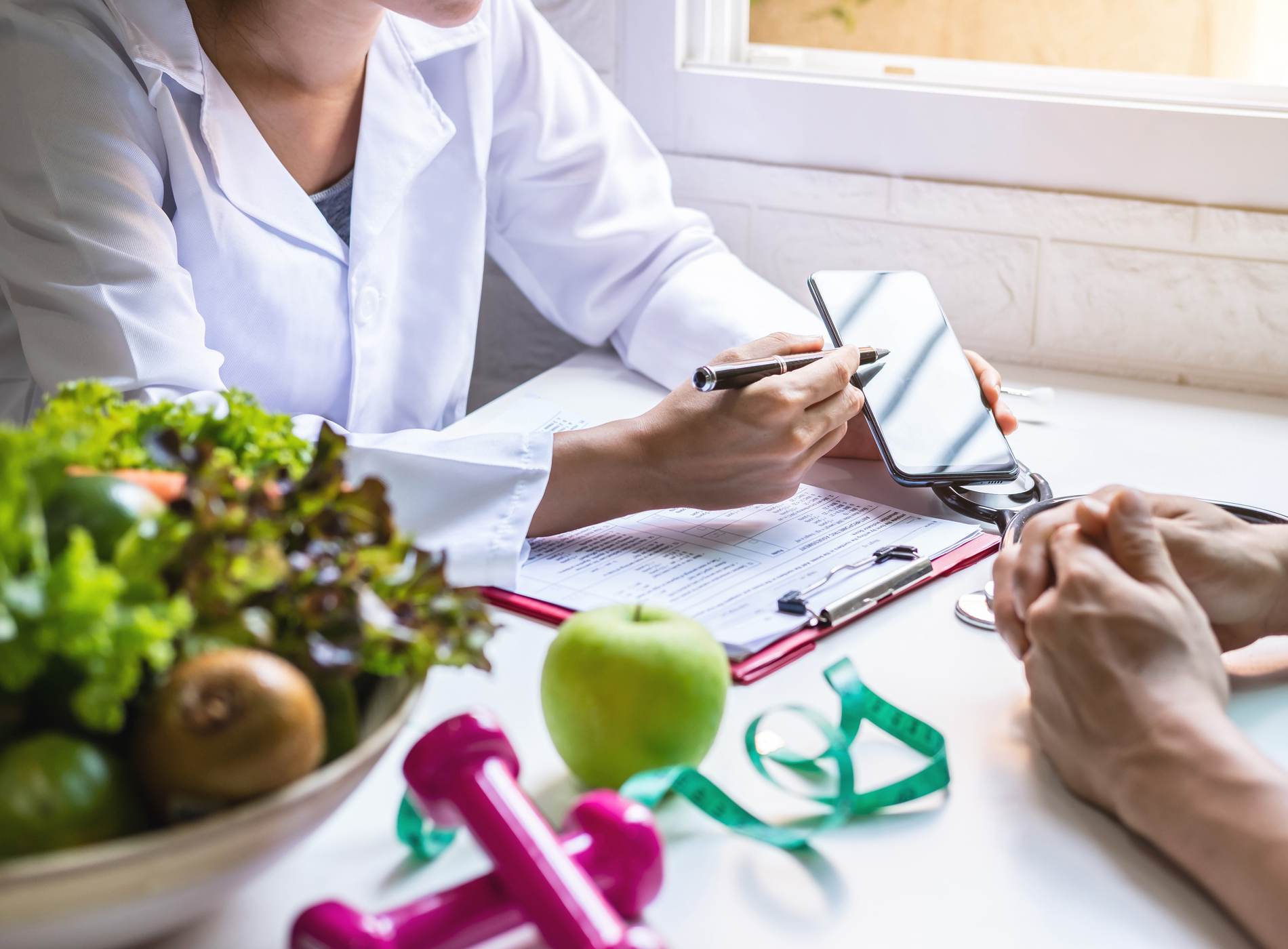 Nutritionist giving consultation to patient with healthy fruit and vegetable, Right nutrition and diet concept