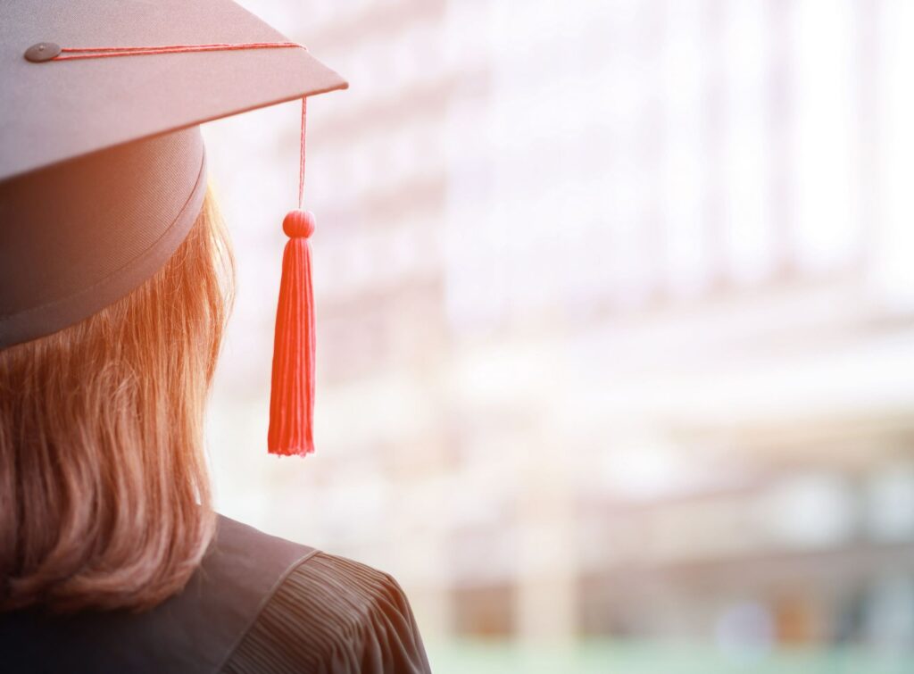 close up hat young women backside group crowd of new graduates during commencement. Concept education congratulation. Graduation Ceremony in University