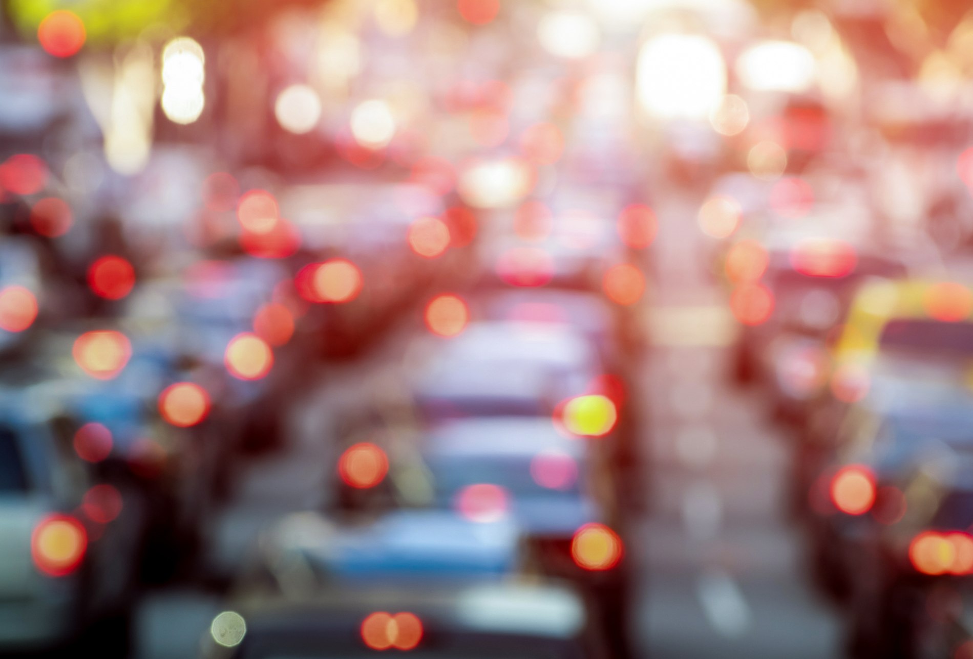 Rush hour with defocused cars and generic vehicles - Traffic jam in Los Angeles downtown - Blurred bokeh postcard of american iconic city with dark contrast sunshine filter - Transportation concept