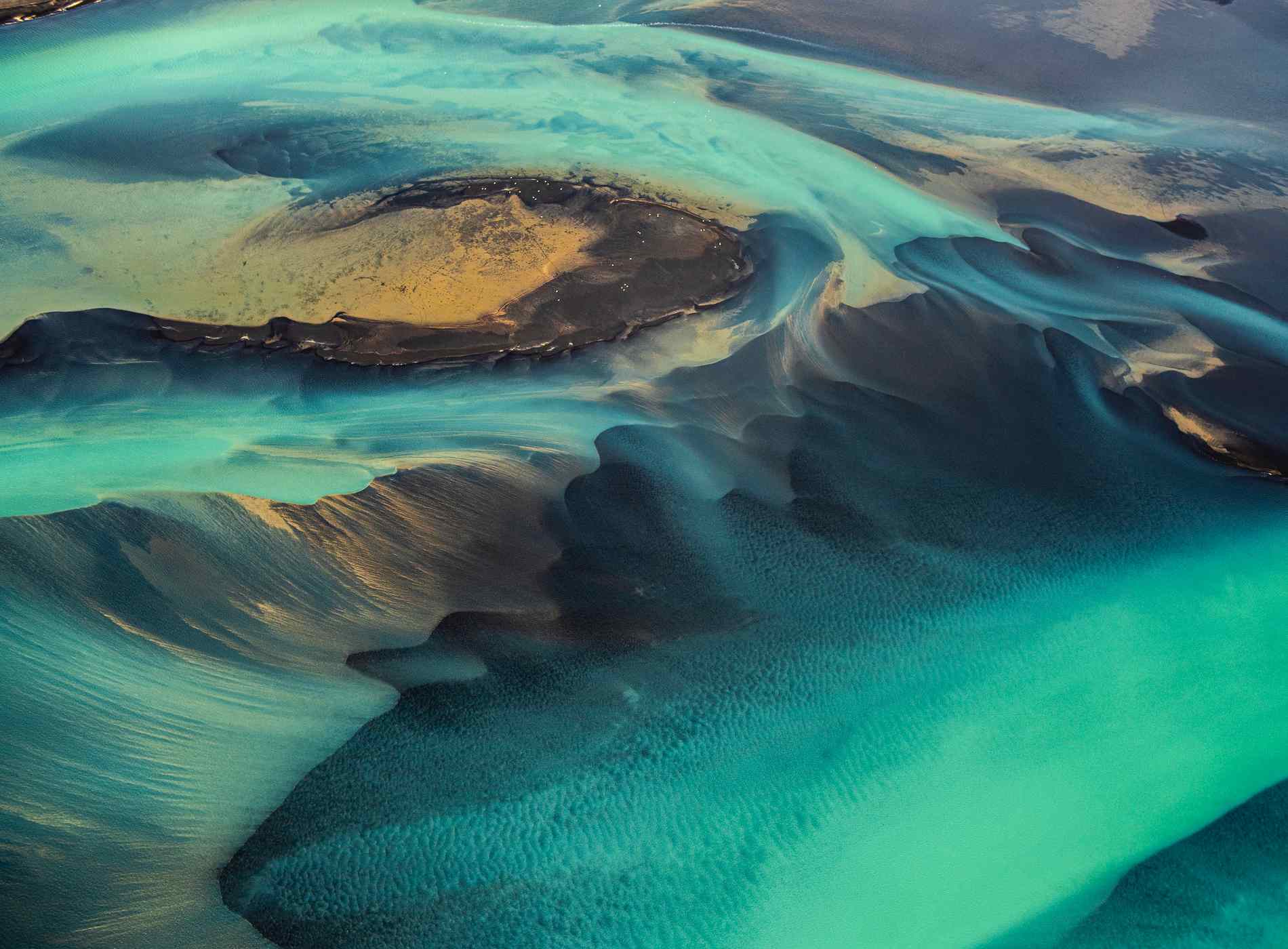 Helicopter view of wonderful turquoise-colored glacial rivers in Iceland.